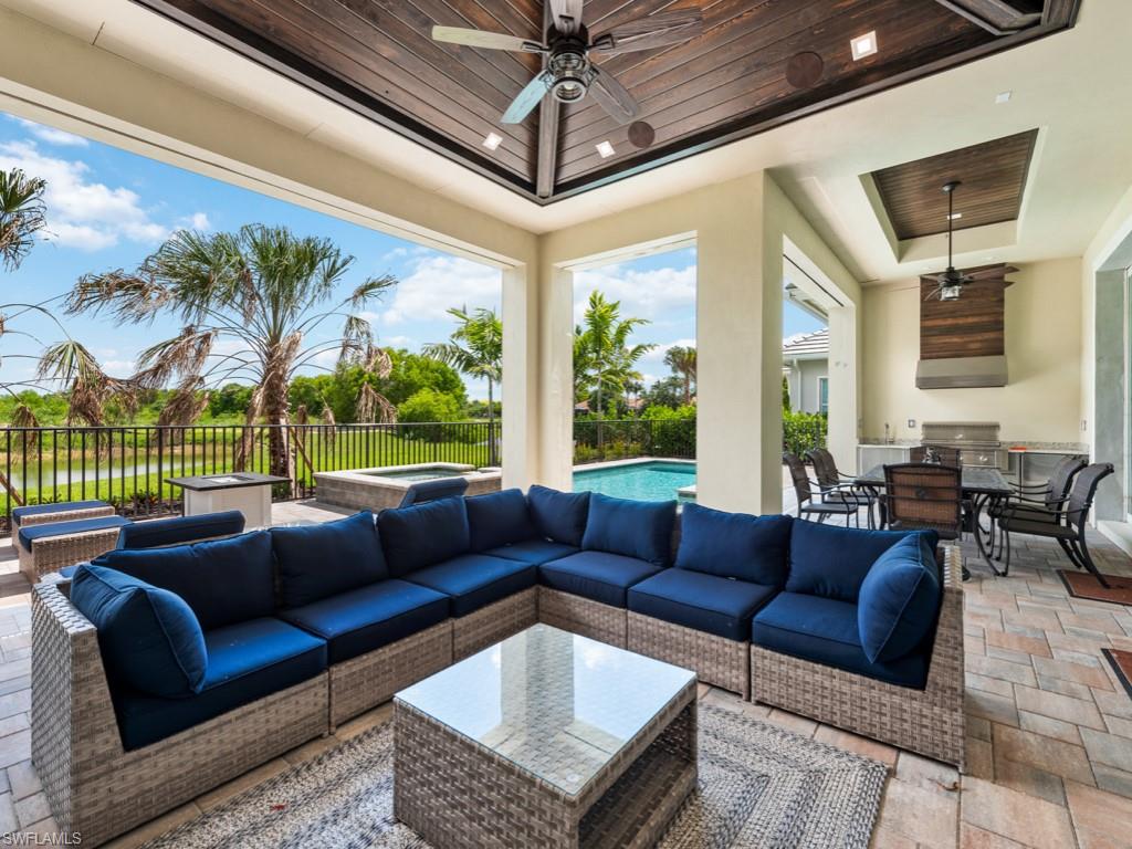 View of patio / terrace featuring grilling area, outdoor lounge area, ceiling fan, and a fenced in pool