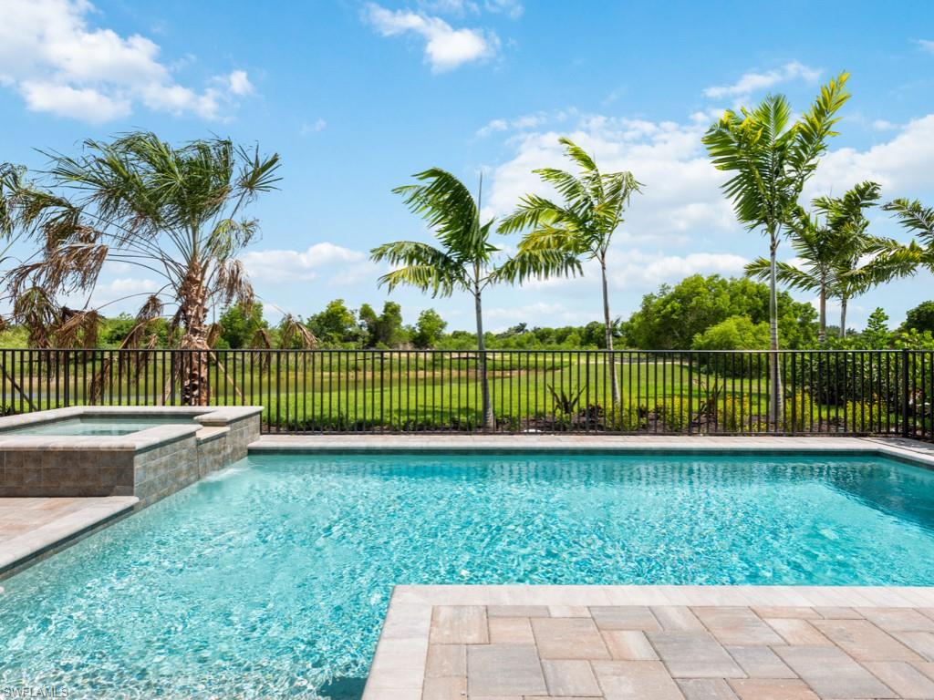 View of swimming pool featuring an in ground hot tub