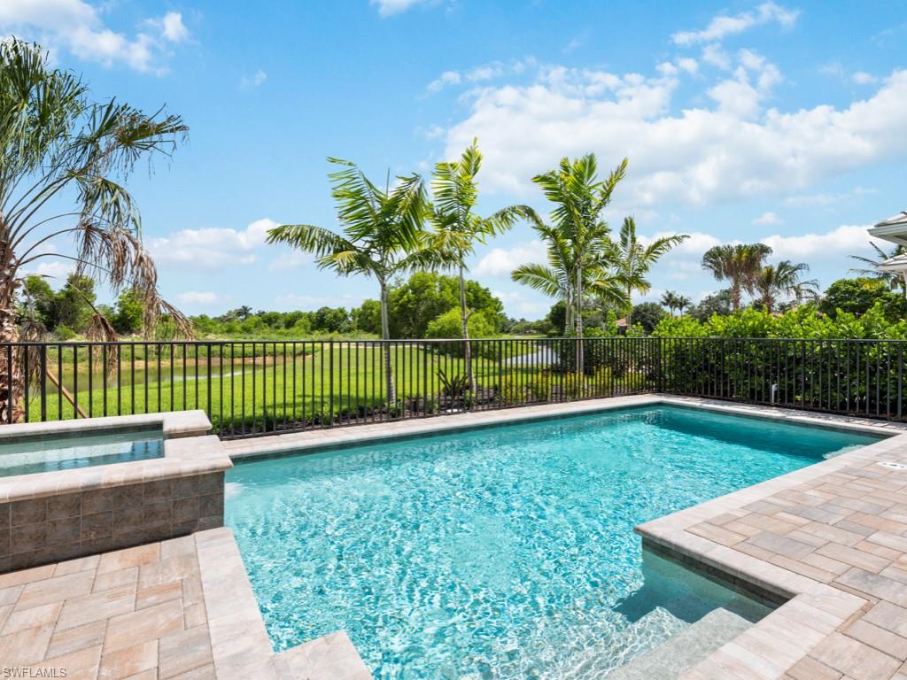 View of pool with an in ground hot tub