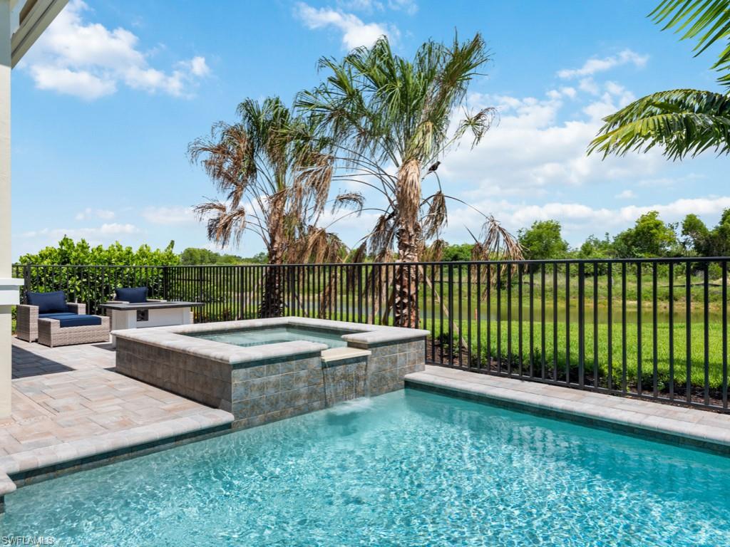 View of pool featuring an in ground hot tub and pool water feature