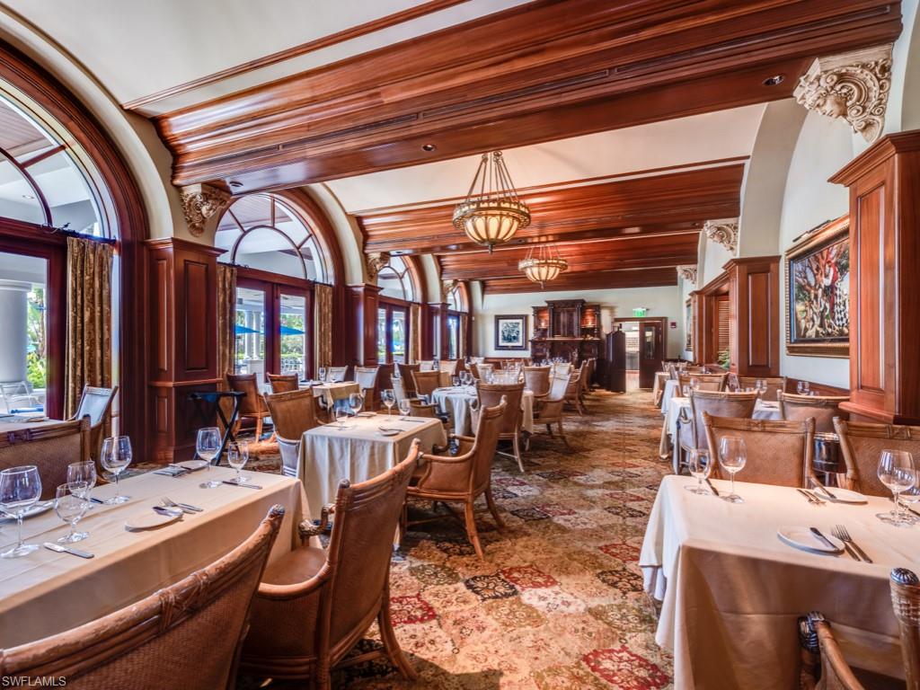 Dining space featuring tile patterned flooring, a notable chandelier, and beam ceiling