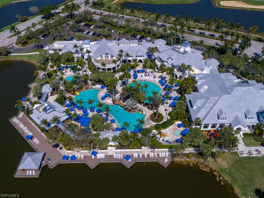 Birds eye view of property with a water view