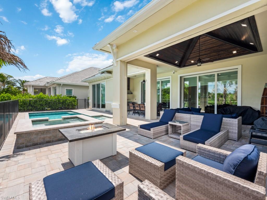 View of patio / terrace featuring an outdoor living space, ceiling fan, and a swimming pool with hot tub