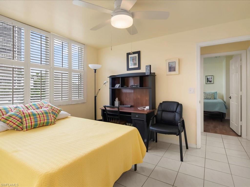 Bedroom with light tile patterned flooring and a ceiling fan