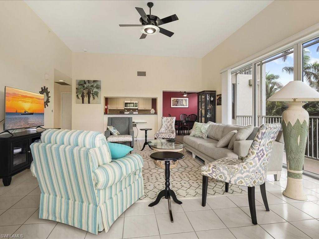 Living area with light tile patterned floors and ceiling fan