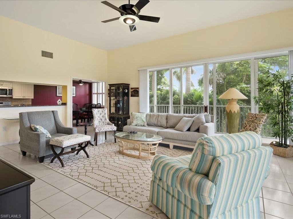 Living room featuring light tile patterned floors and a ceiling fan