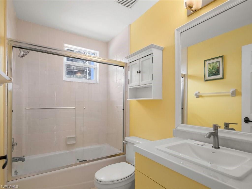 Full bathroom featuring bath / shower combo with glass door and vanity