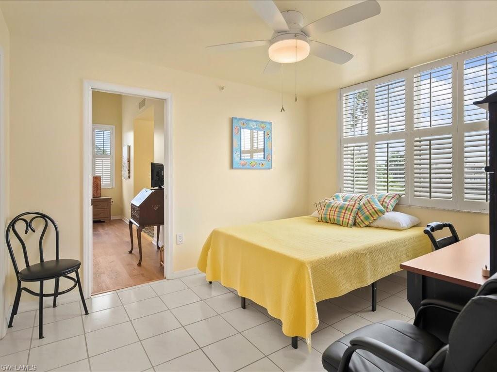 Bedroom with light tile patterned flooring and ceiling fan