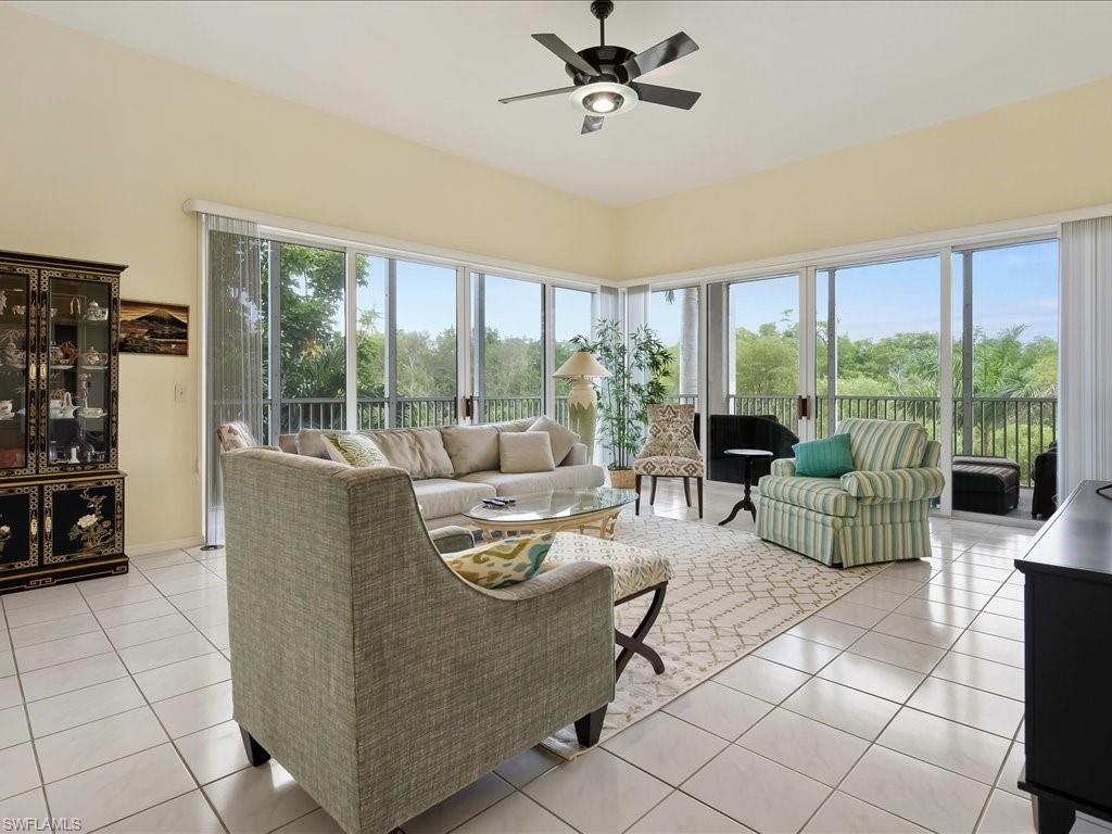 Living area featuring light tile patterned flooring and a ceiling fan