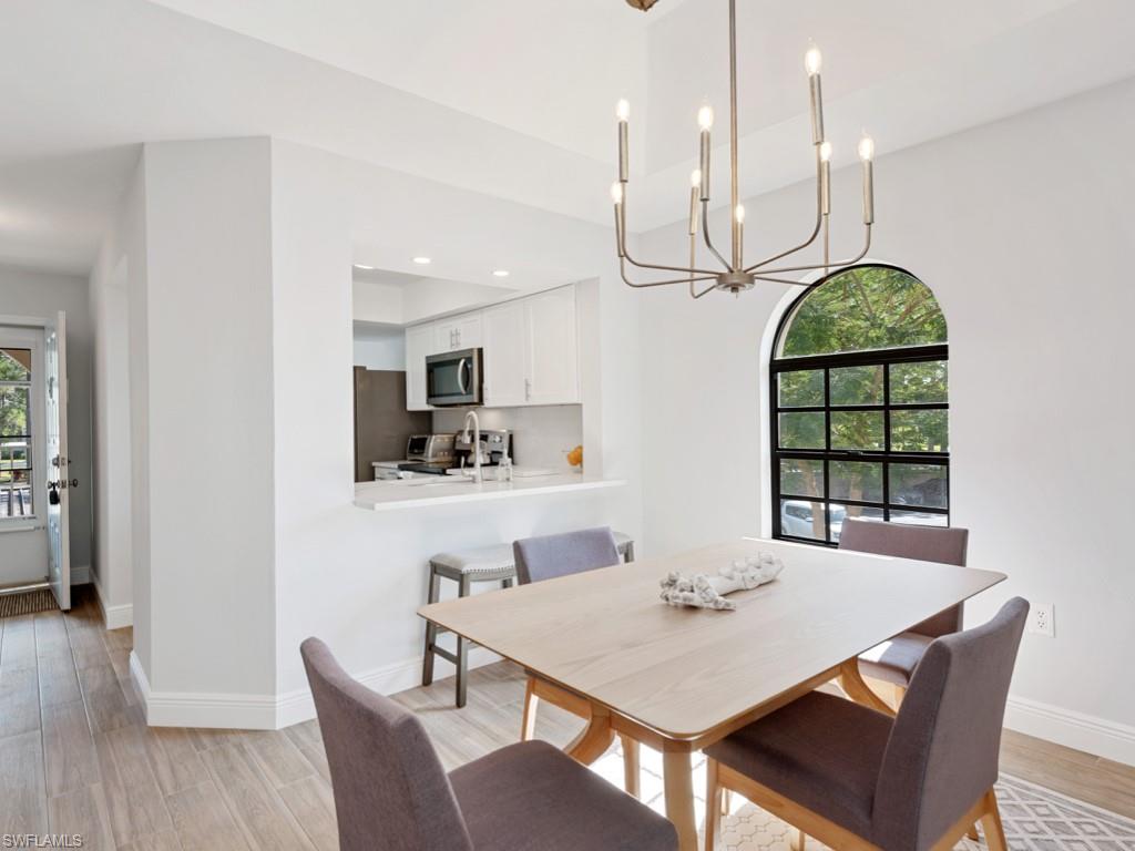 Dining area with a chandelier and light hardwood / wood-style flooring