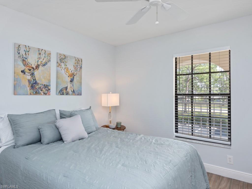 Bedroom featuring ceiling fan and wood-type flooring