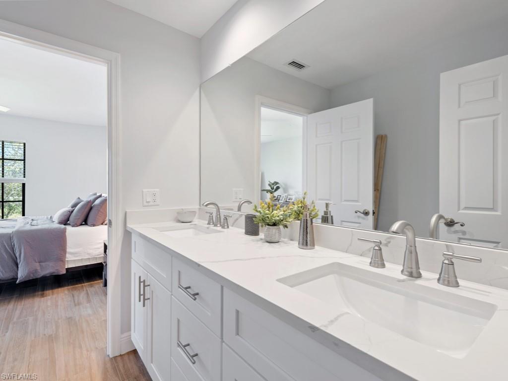 Bathroom with hardwood / wood-style floors and double vanity