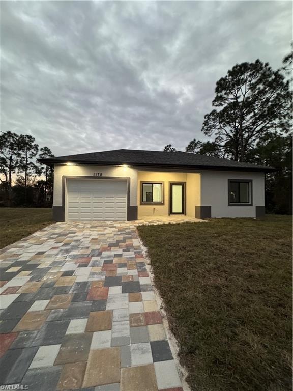View of front facade with a front yard and a garage
