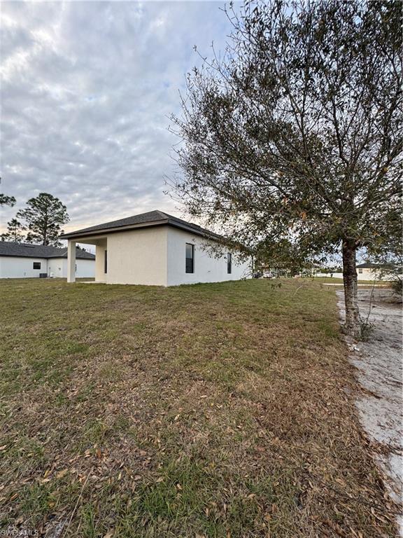 View of property exterior featuring a yard