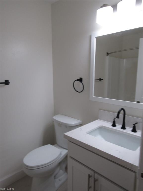 Bathroom featuring a white vanity with an integrated sink, matte black faucet, and a wall-mounted mirror