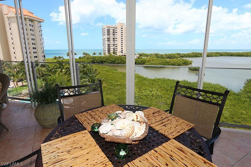 Outdoor patio with tile flooring and a glass railing system