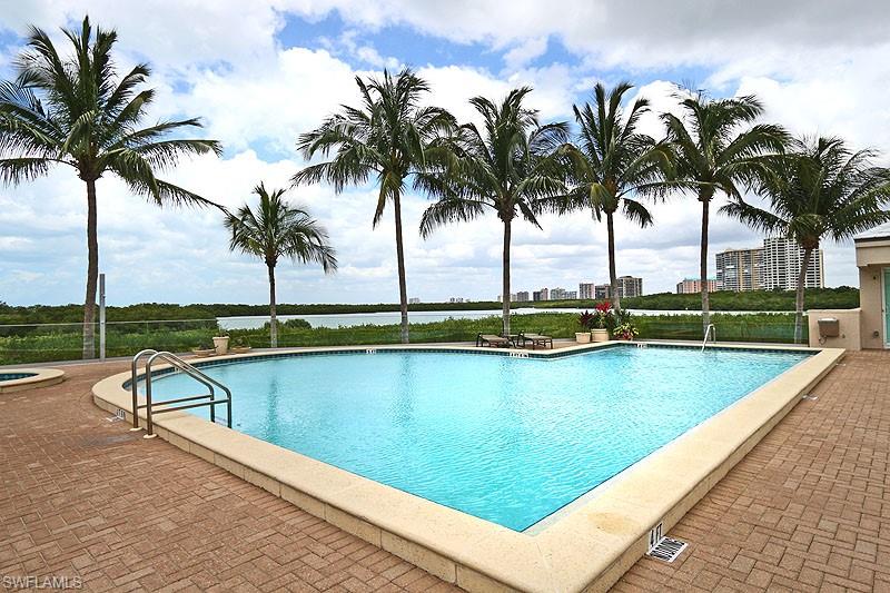 Geometric swimming pool with paver decking and integrated spa