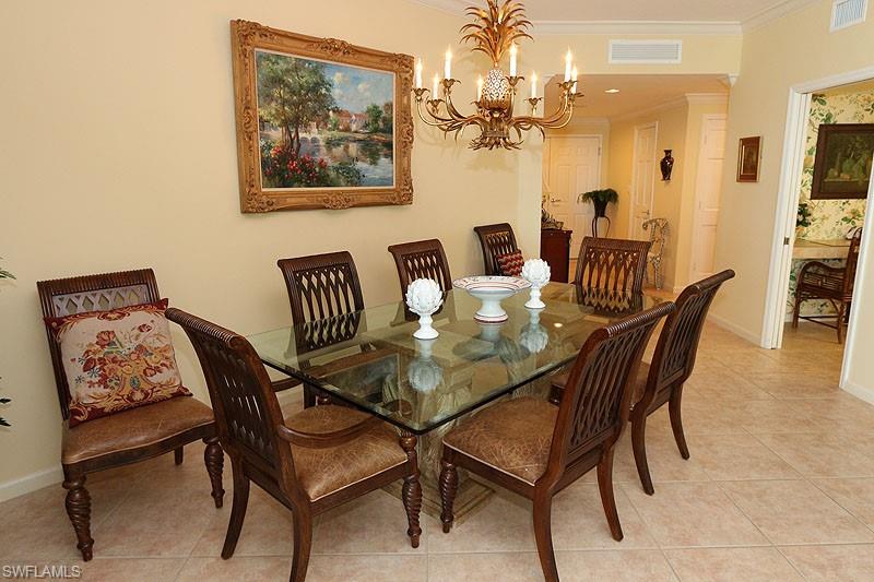 Dining area featuring neutral wall tones and large format tile flooring