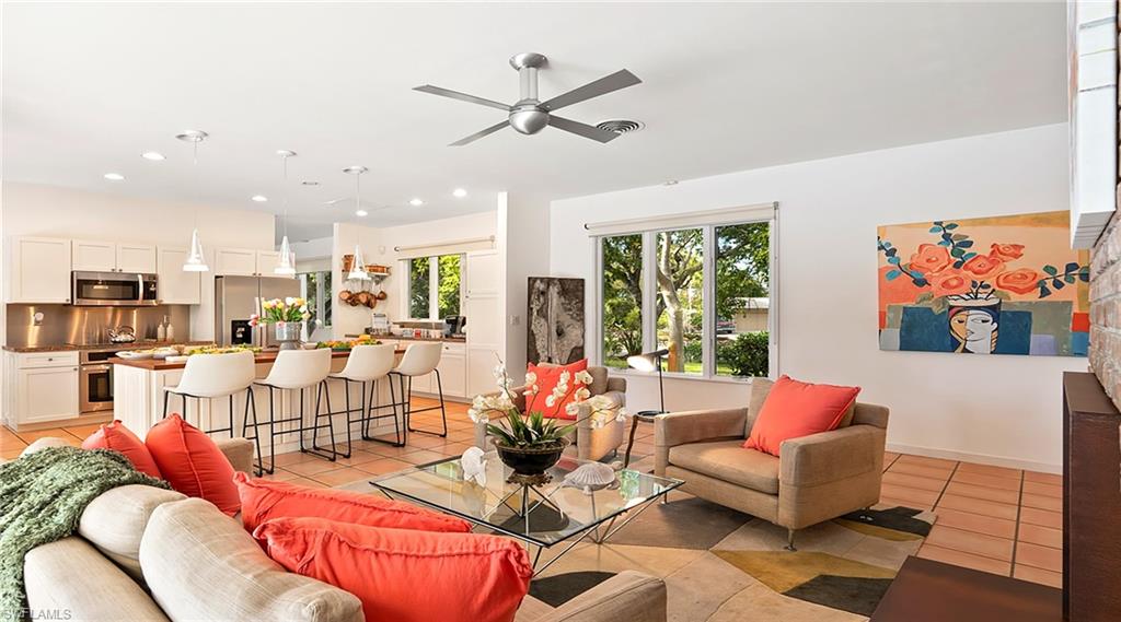Living room featuring light tile patterned floors, a ceiling fan, and recessed lighting