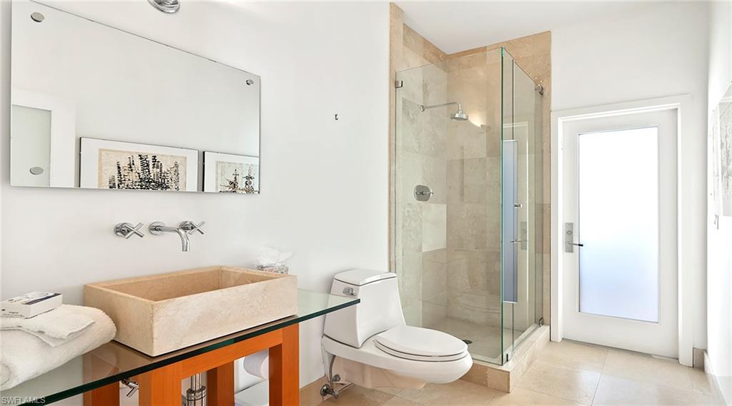 Bathroom with a shower stall and tile patterned flooring