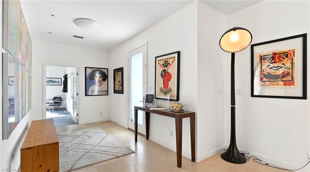 Hallway featuring an office area and baseboards