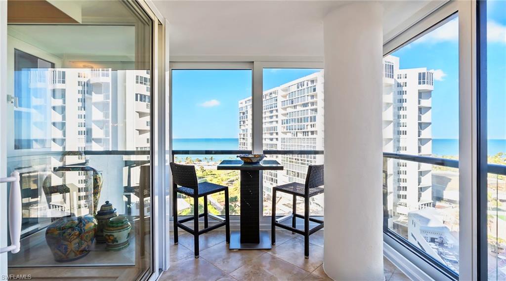 Balcony featuring a water view and a view of city