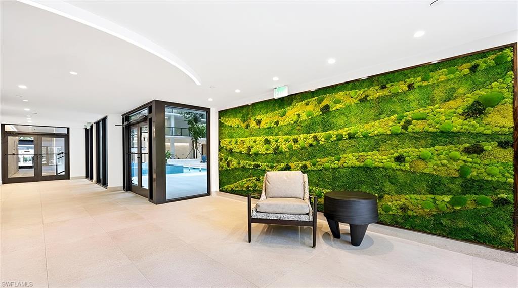 Community lobby featuring floor to ceiling windows and recessed lighting