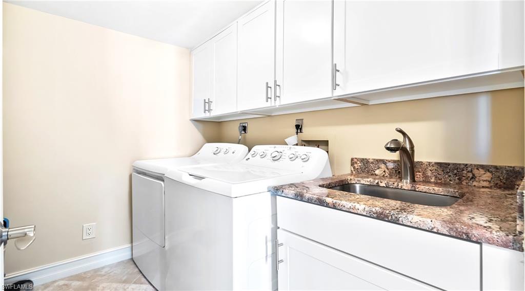 Washroom with washer and dryer and cabinet space