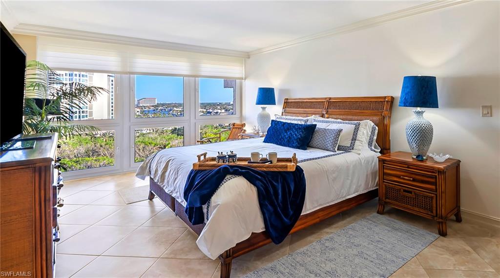 Bedroom featuring crown molding and light tile patterned floors