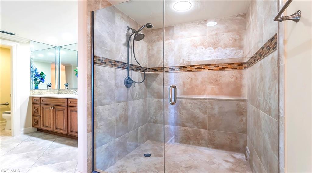Full bathroom featuring vanity, a shower stall, and recessed lighting