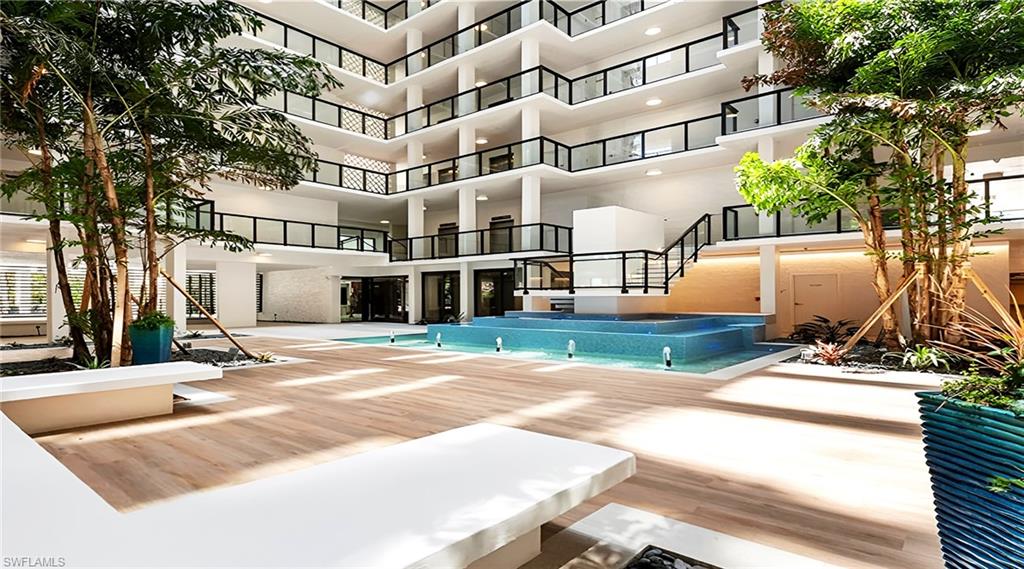 View of pool featuring an infinity pool, a patio, and a balcony