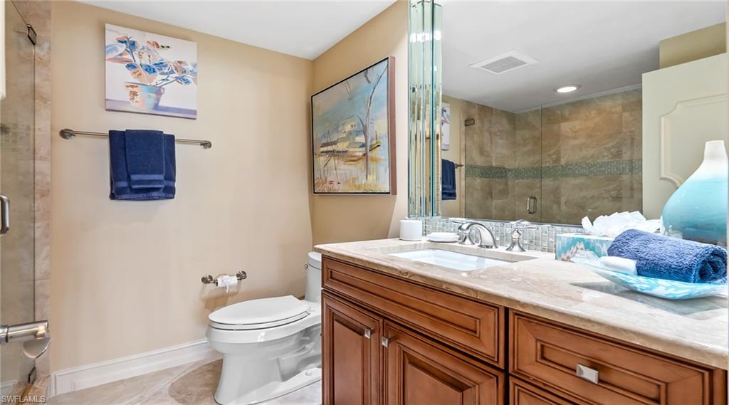 Bathroom with vanity, a stall shower, and light tile patterned flooring