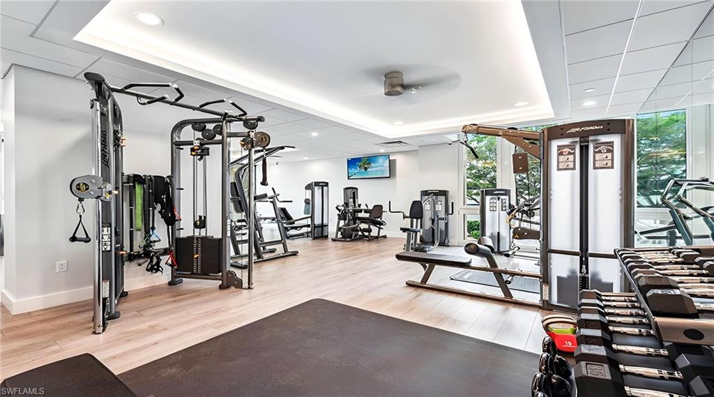 Workout area with floor to ceiling windows and recessed lighting