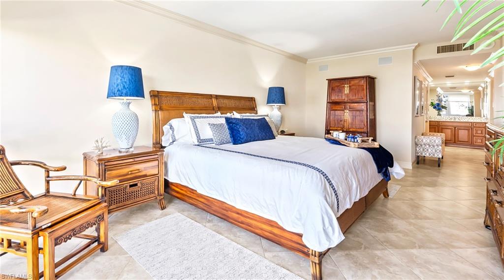 Bedroom featuring crown molding and light tile patterned floors