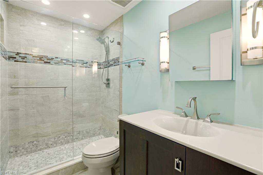 Guest Bathroom featuring vanity, a stall shower, and recessed lighting