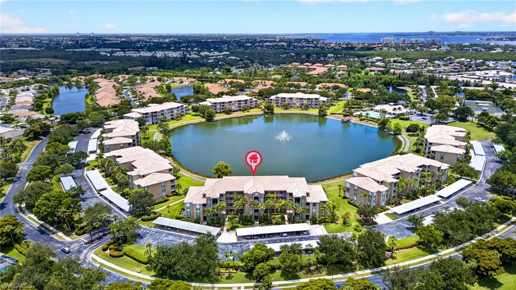 Lakeside condominium building with tile roof and covered parking