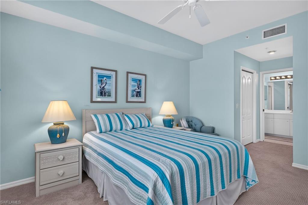 Bedroom featuring light blue walls and neutral carpet flooring