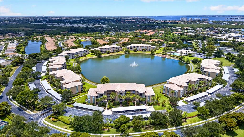 Expansive lakefront community featuring multiple residential buildings surrounding a central lake with a fountain