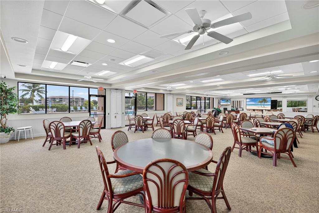 Spacious common area featuring extensive window lines, recessed lighting, and multiple ceiling fans