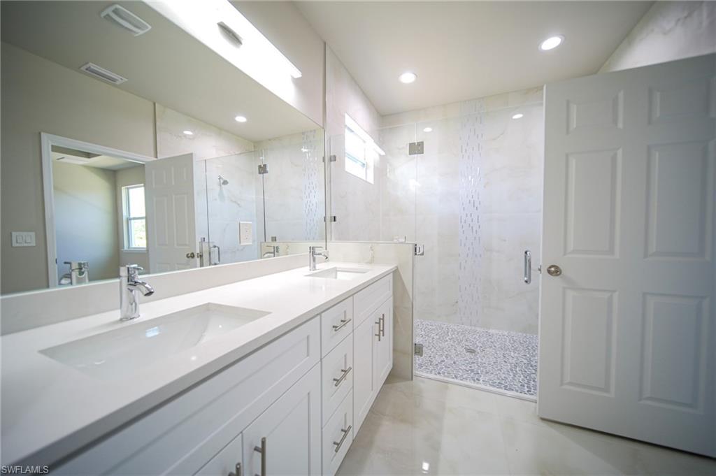 The Master Bathroom Comes With Dual Sinks, Quartz Countertops, Flat Panel Real Wood Cabinets & Drawers, And A Walk-In Glass Tiled Shower With Seating!
