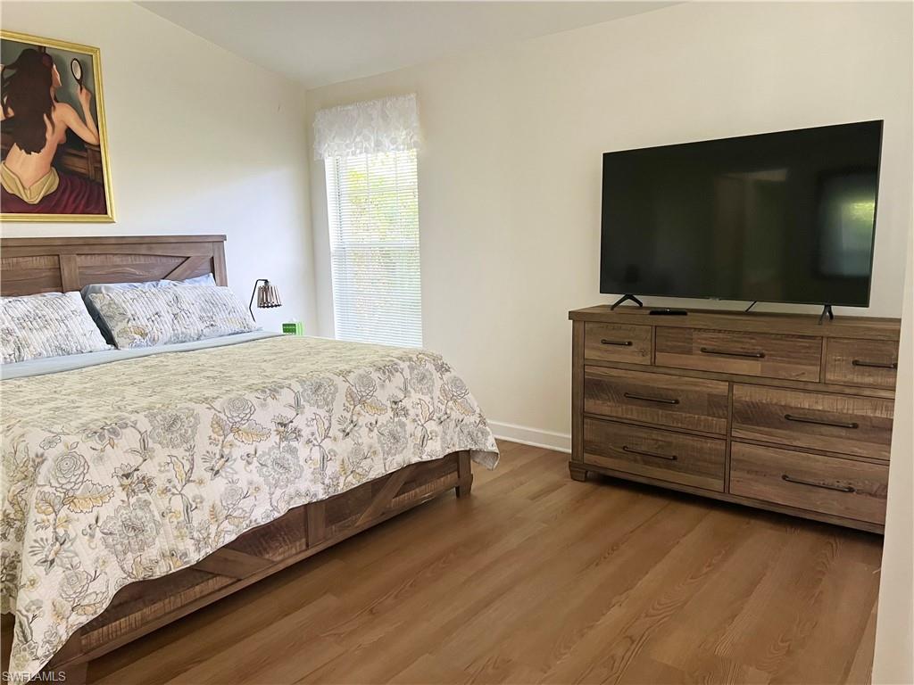 Bedroom with light hardwood / wood-style floors