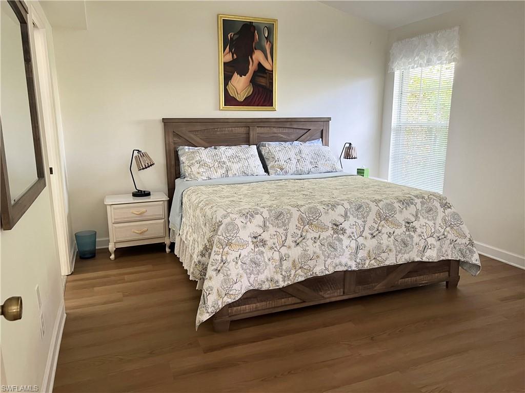 Bedroom with hardwood / wood-style flooring