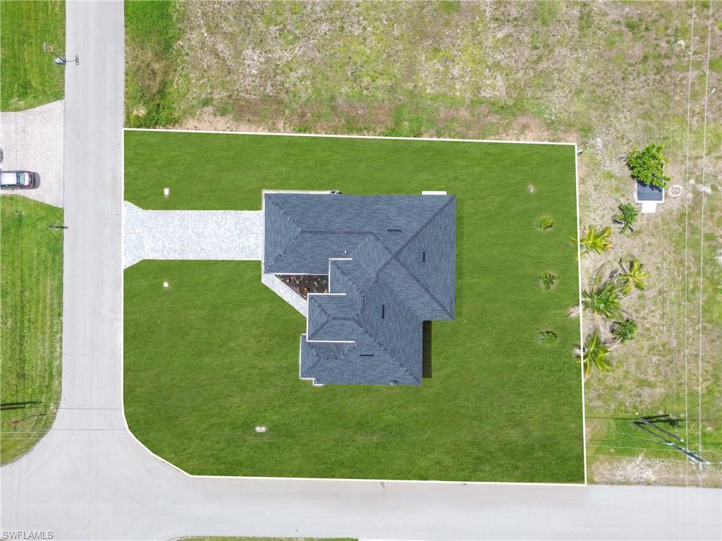 Aerial view showcasing a newly constructed residence on a corner lot