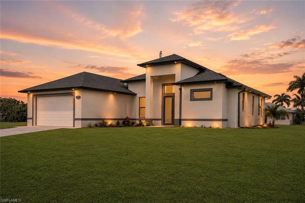 Contemporary stucco exterior with a dark shingle roof, integrated garage, and a full-light entry door