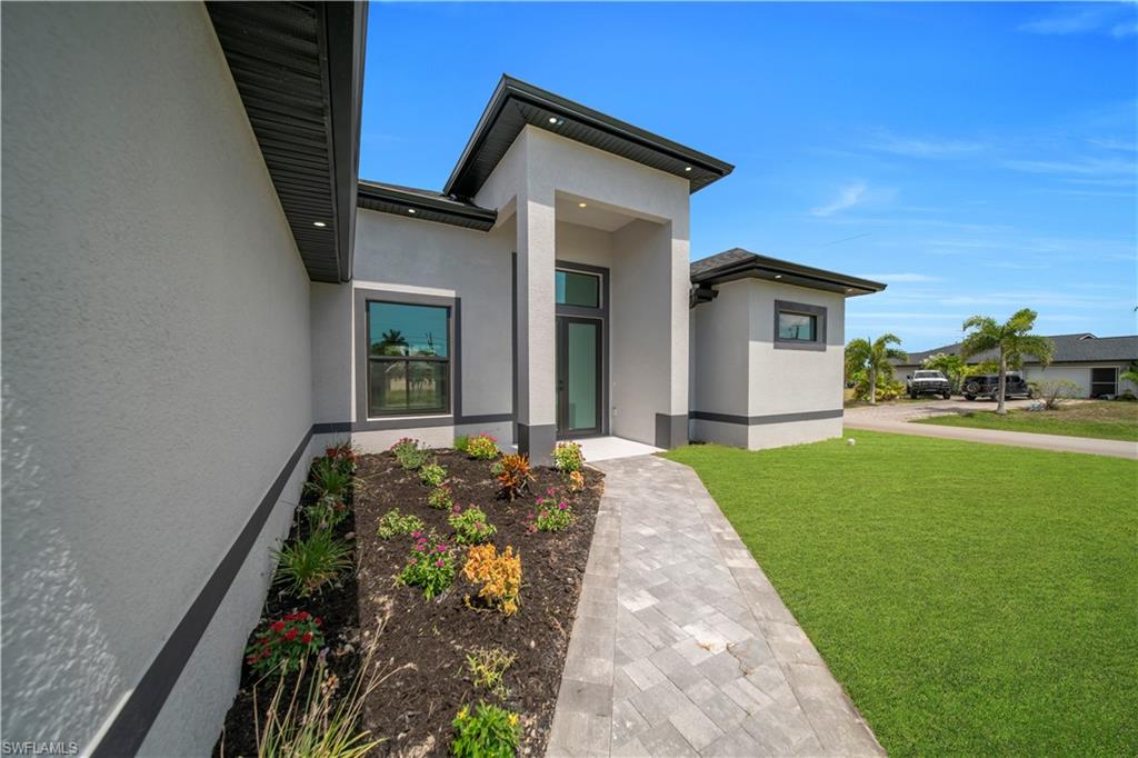 Modern exterior featuring a prominent entryway with an opaque glass door