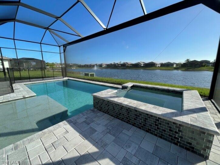 pool and spa with panoramic screening and sun shelf for lounging.  Lake and water display!
