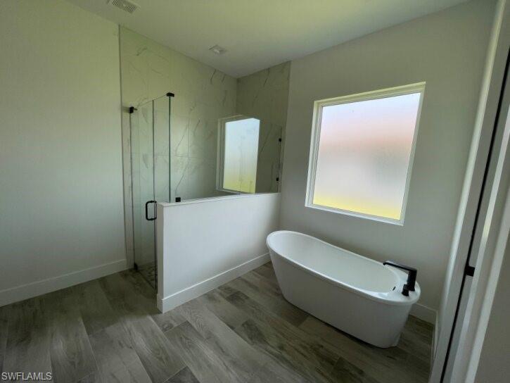 Master bathroom with soaking tub and separate shower