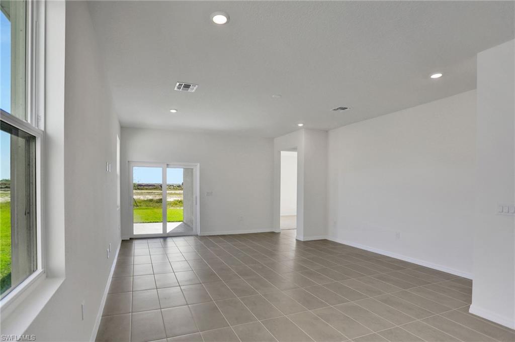 Empty room featuring recessed lighting and light tile patterned floors