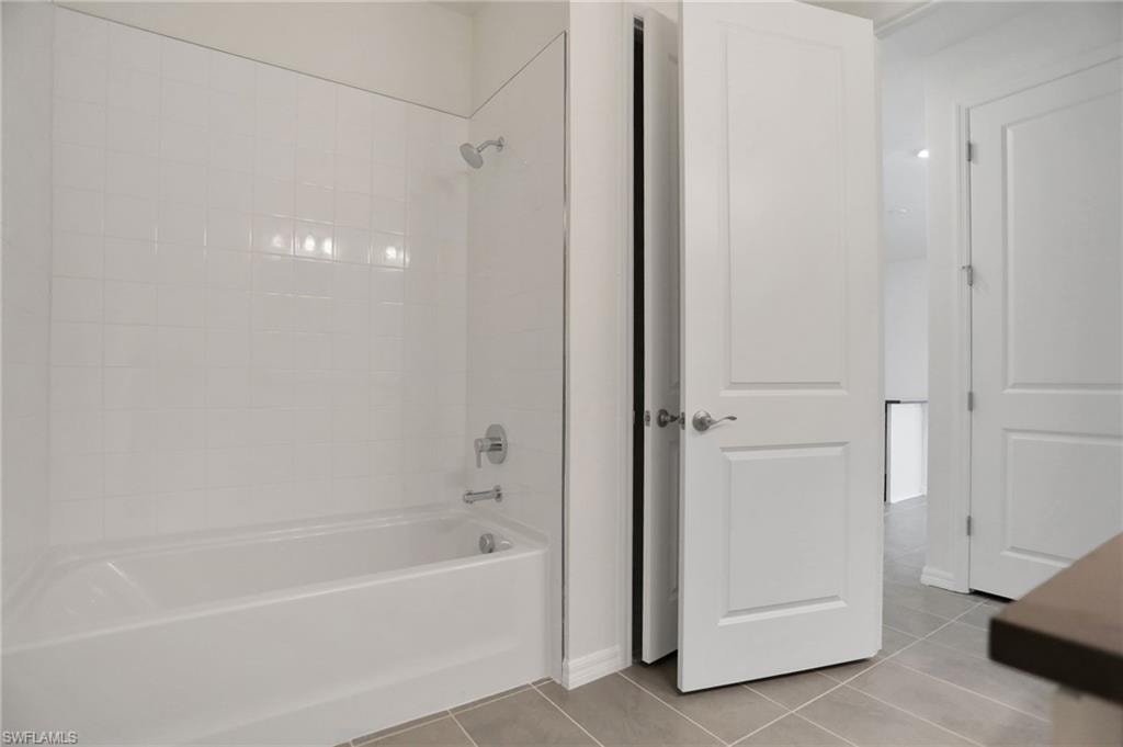 Bathroom featuring shower / bath combination and light tile patterned floors
