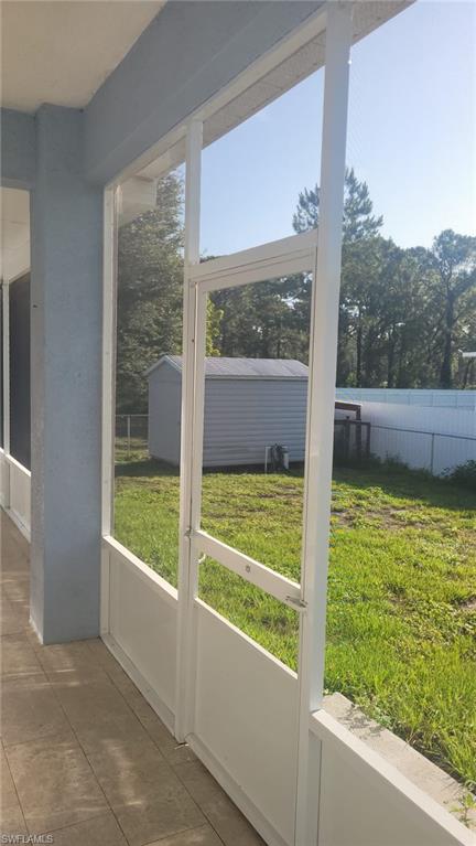 Screened patio with tile flooring and a white aluminum frame enclosure